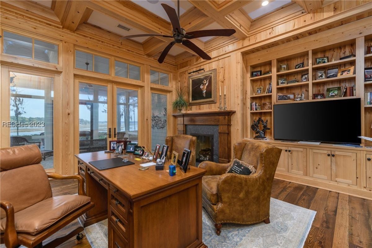 Home office with a fireplace and a TV.