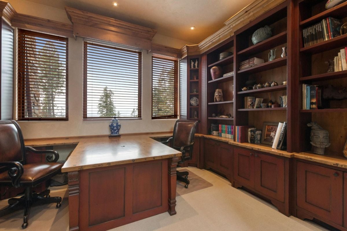 Home office with custom lighting, custom cabinetry and glass windows.