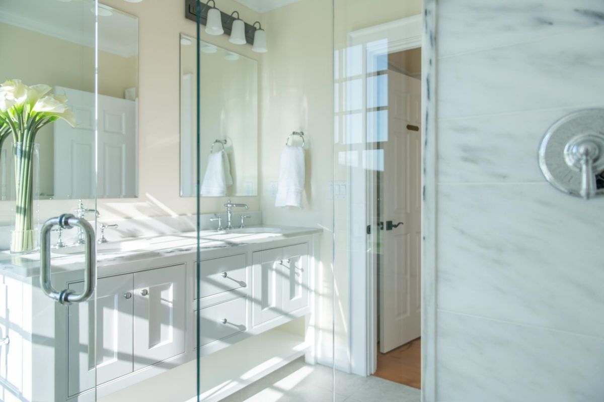 Bathroom with sinks, mirrors, and custom cabinetry.