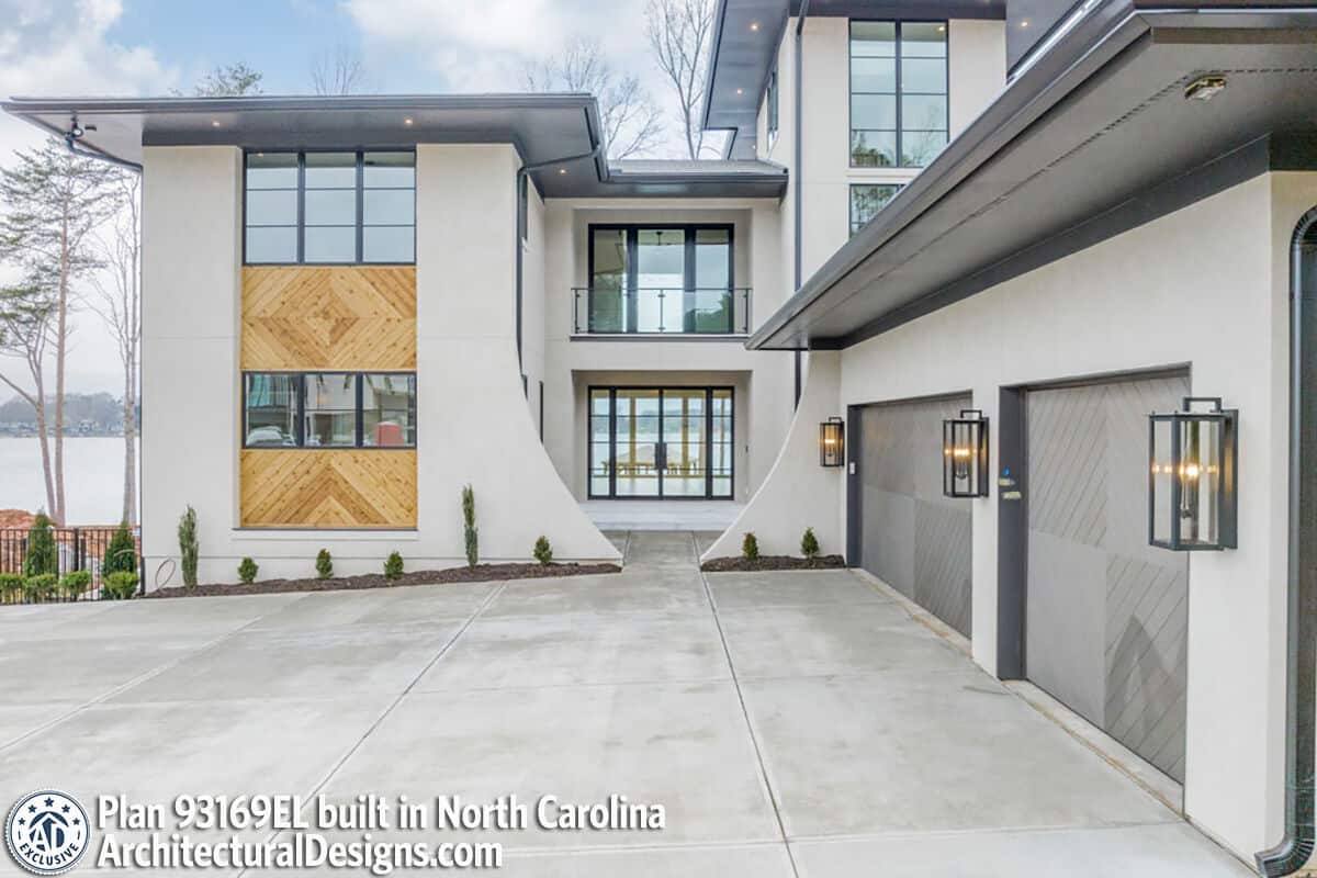 Front view with a covered entry porch and a side-loading garage complemented with a concrete driveway.