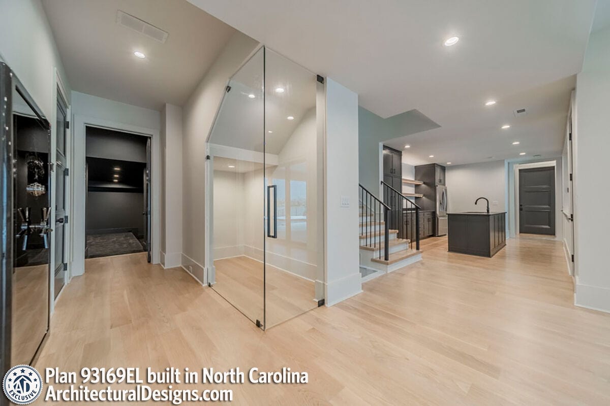 Basement with media room, a wet bar, and a glass-enclosed wine cellar.