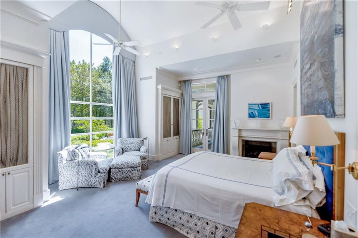 Bedroom with sofa and fireplace.