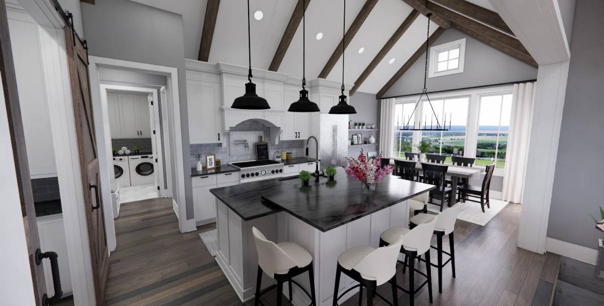 Kitchen with white cabinets, contrasting marble countertops, and a center island with an eating counter.