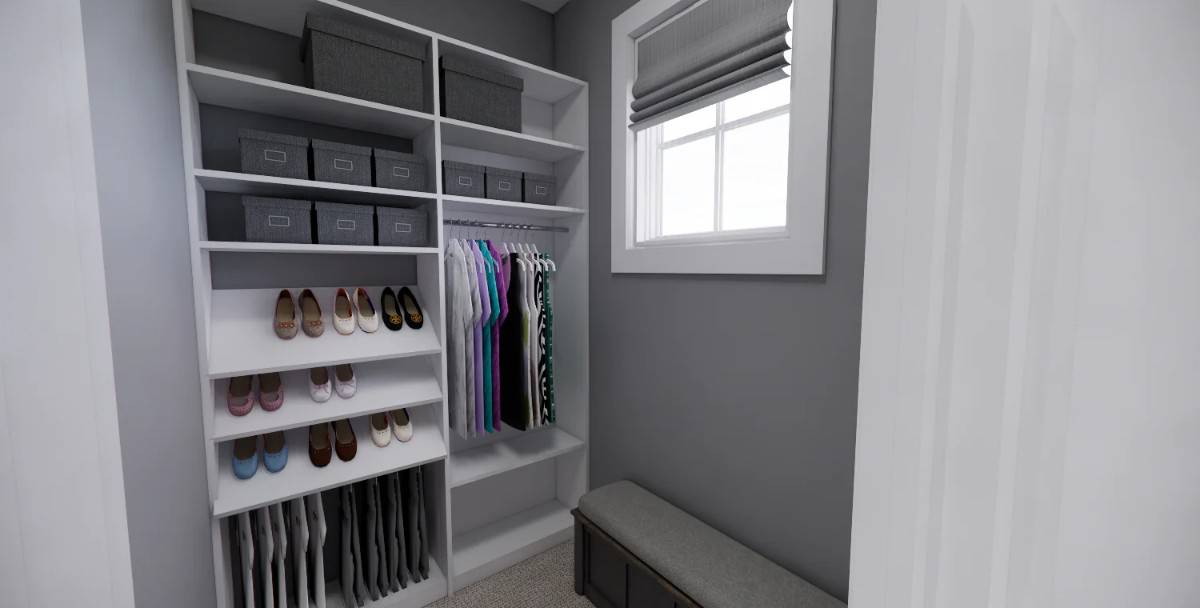 Primary walk-in closet with white shelves and a cushioned bench under the framed window.