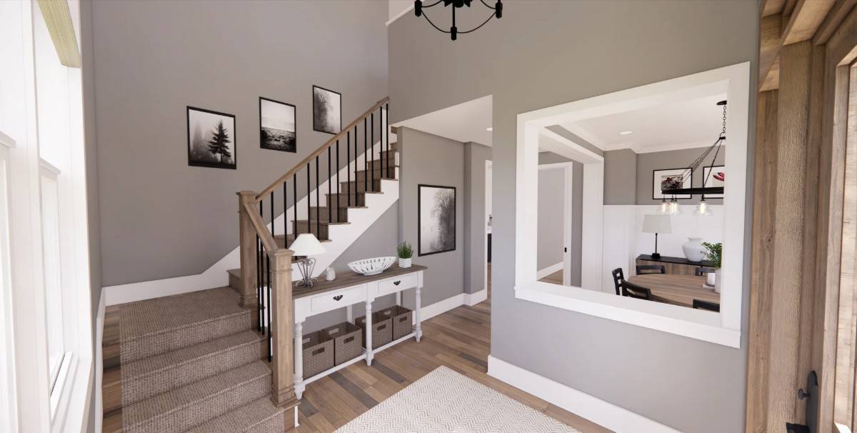 Foyer with a wood and white console table against the wooden staircase.