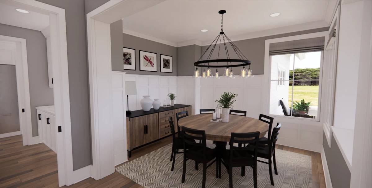 Dining room with a round dining set and a wooden buffet table adorned with vases and framed artworks.