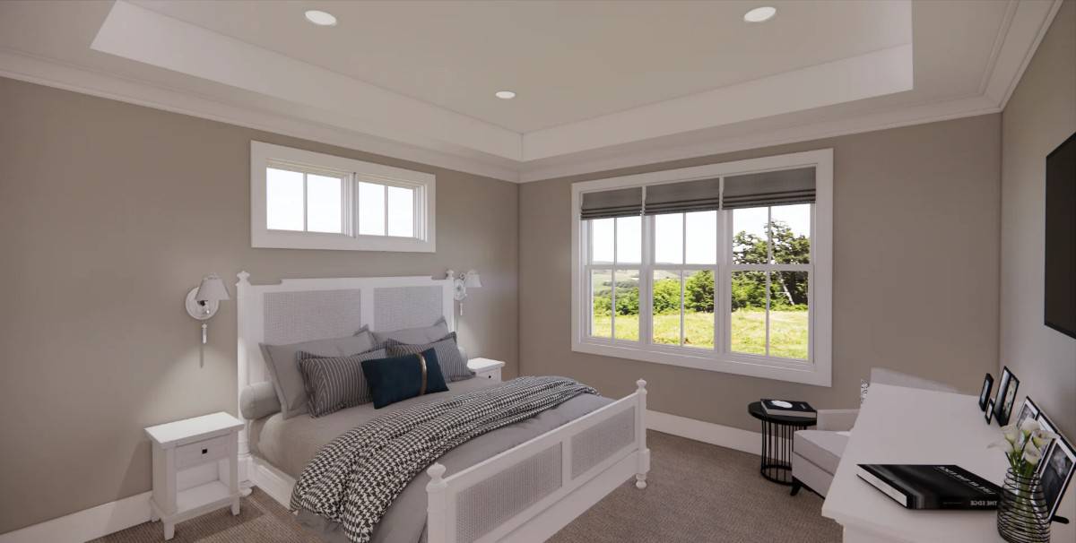 Primary bedroom with white furnishings under a tray ceiling.