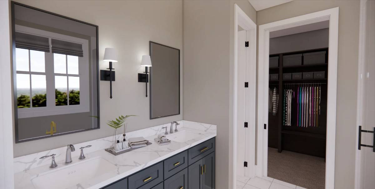 Primary bathroom with a dual sink vanity and a walk-in closet.