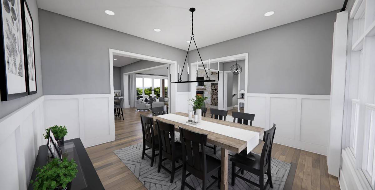 Dining room with half wainscoted walls and a wooden dining set sitting on a patterned area rug.