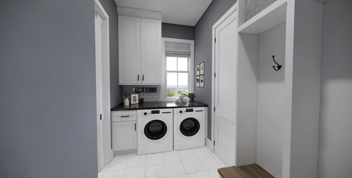 Laundry room with front-load appliances, white cabinets, and a white-framed window allowing natural light in.