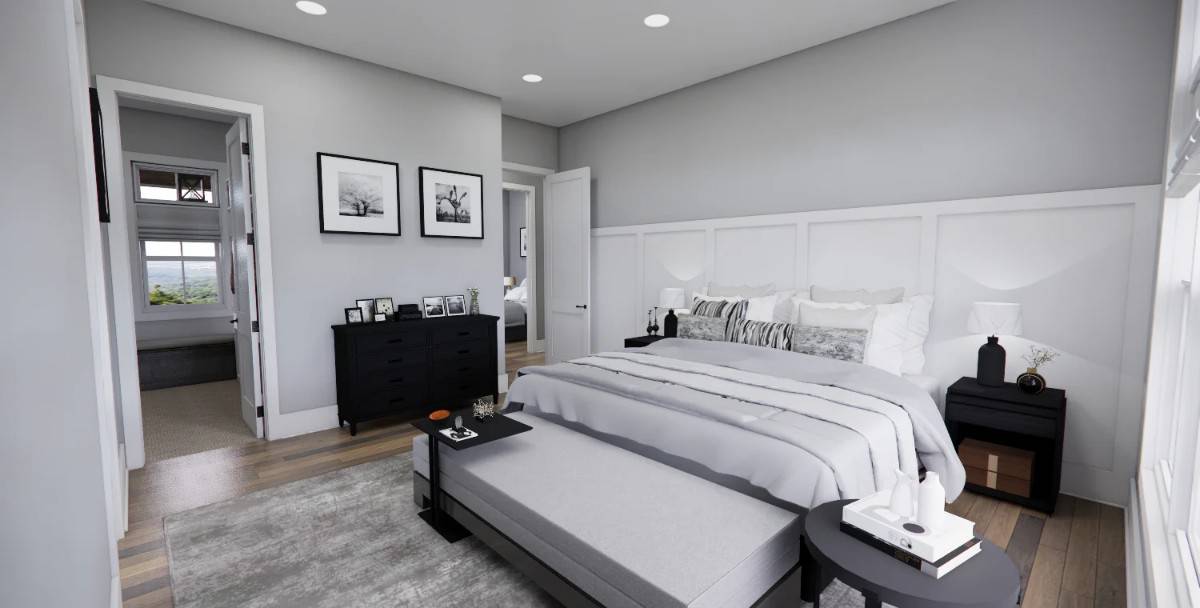 Primary bedroom with a paneled accent wall and dark wood furnishings over hardwood flooring.