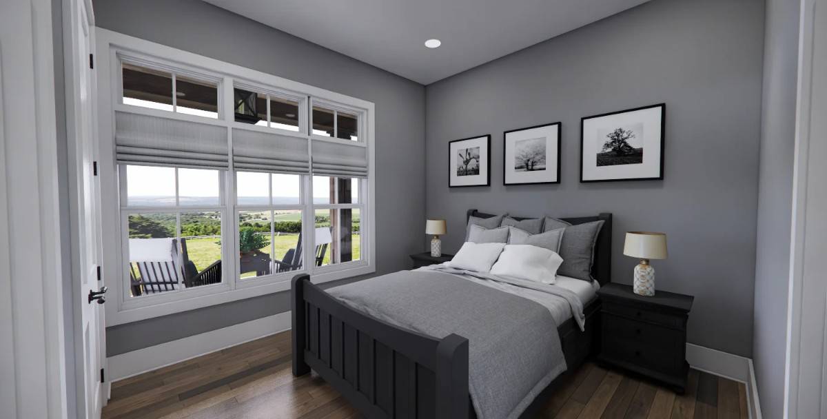 Guest bedroom with black furnishings and a trio of windows that look out the front porch.