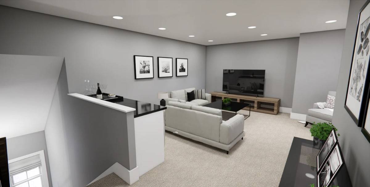 Loft with gray sectionals, a bar, and a TV sitting on a wooden coffee table.