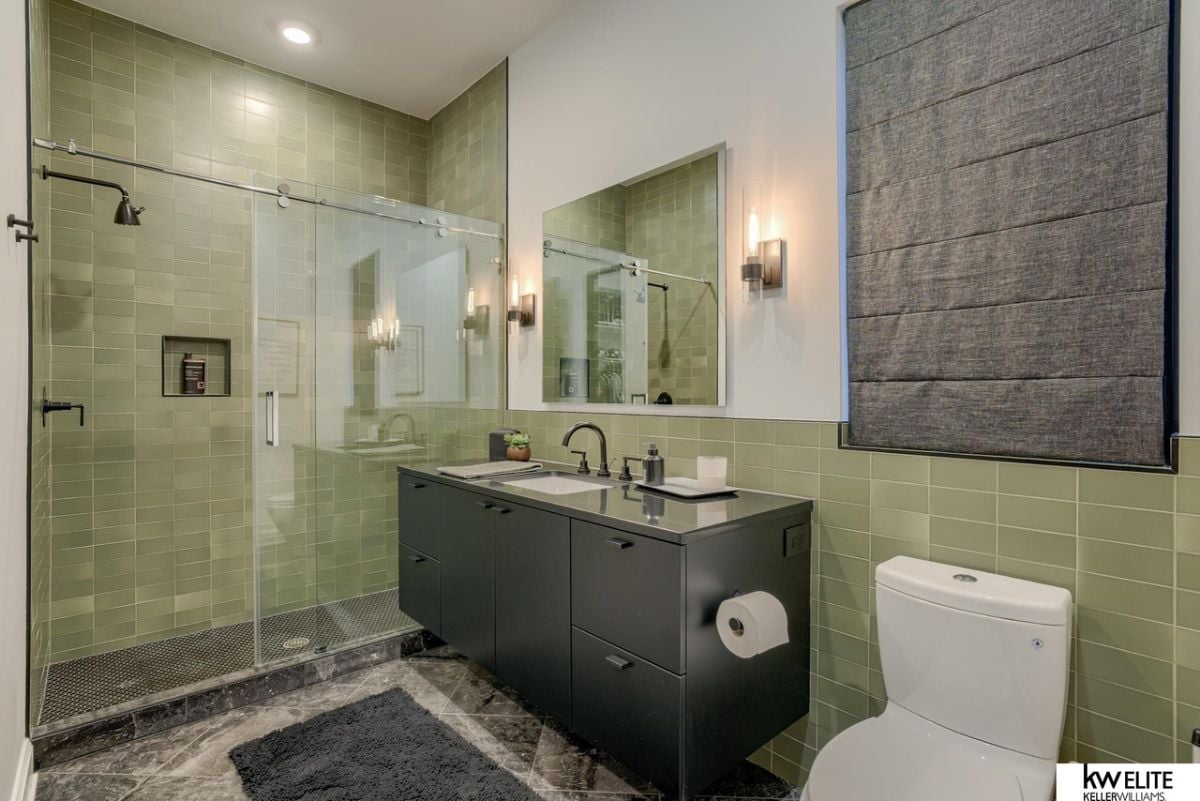 Bathroom's shower, toilet and sink.