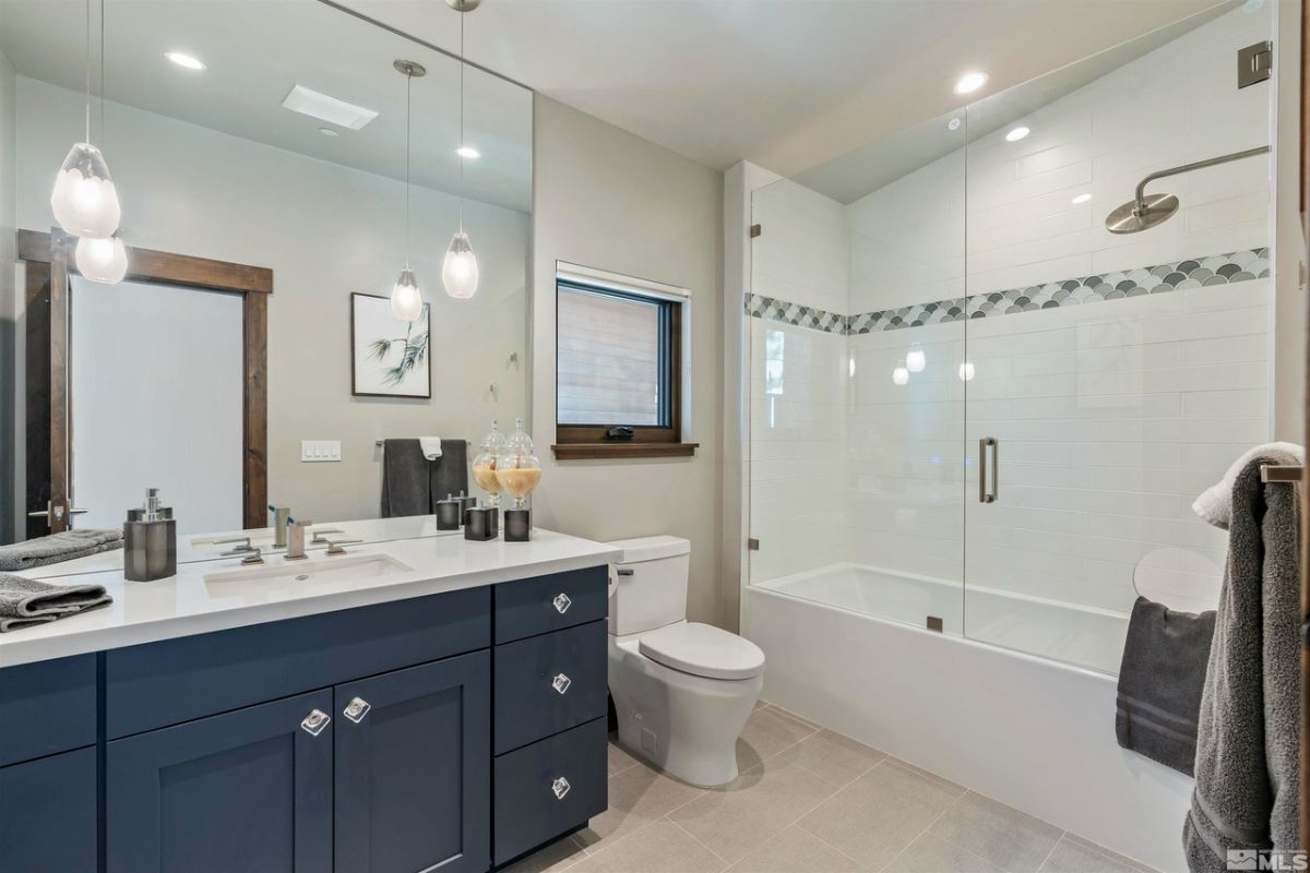 Bathroom's toilet, shower and sink.