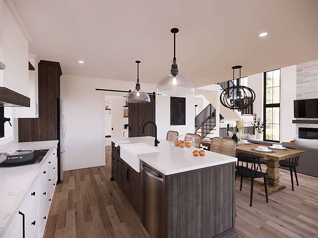 Kitchen with ample storage, marble countertops, and a farmhouse sink fitted on the breakfast island.