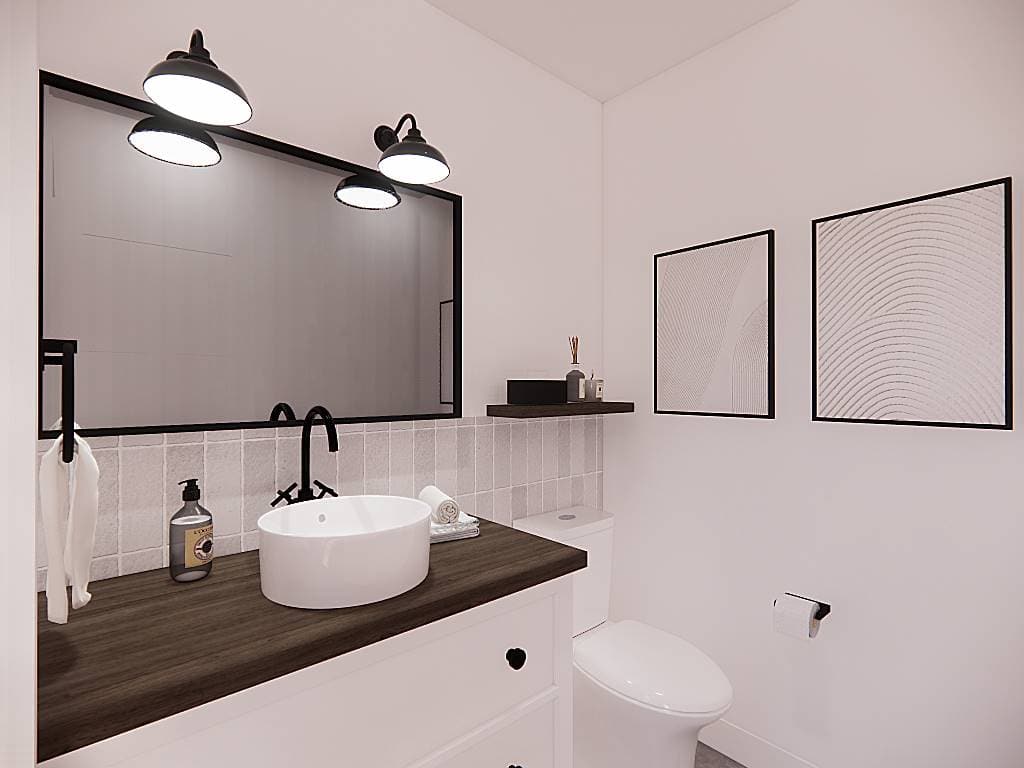 Powder room with a vessel sink vanity and white walls adorned by minimalist artworks and a large mirror.