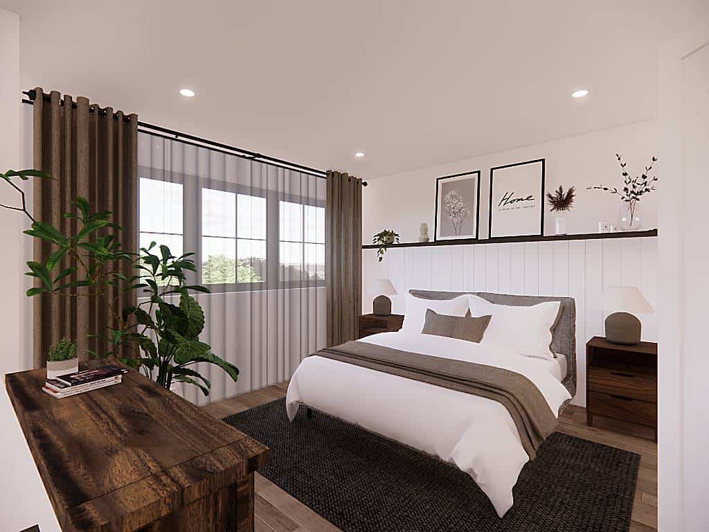 Primary bedroom with an upholstered bed, rustic tables, and framed windows dressed in sheer curtains.