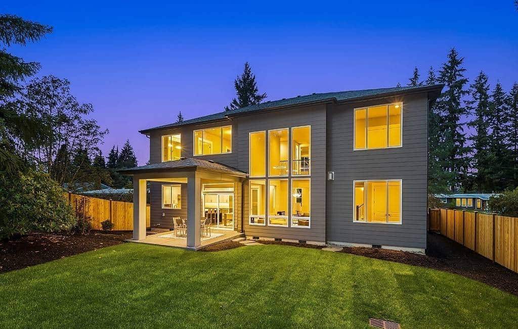 Rear view of the house showcasing its huge windows and covered patio.
