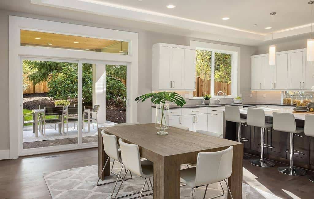 Casual dining with modern chairs and a wooden table over a patterned area rug.
