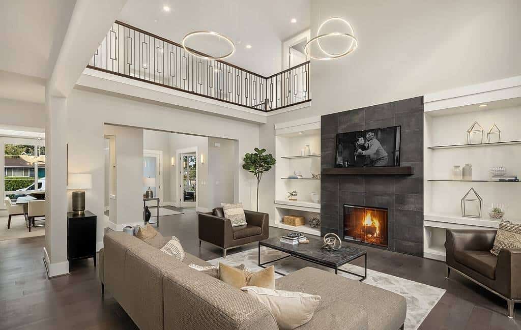 The family room includes a two-story ceiling and a large fireplace flanked by inset shelves.