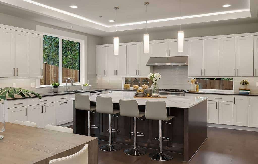 Four bar stools complement the kitchen island.