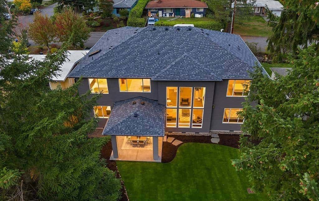 Aerial view of the house showcasing its hipped rooflines and outdoor living space.