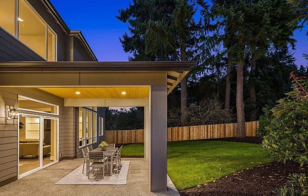 Covered patio with pillars, sliding glass doors, and an outdoor dining.