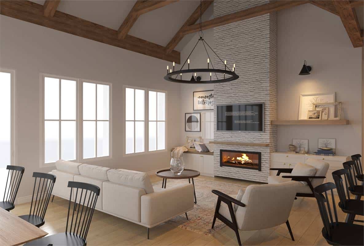 Living room with beige seats, a wall-mounted TV, and a brick fireplace flanked by base cabinets.