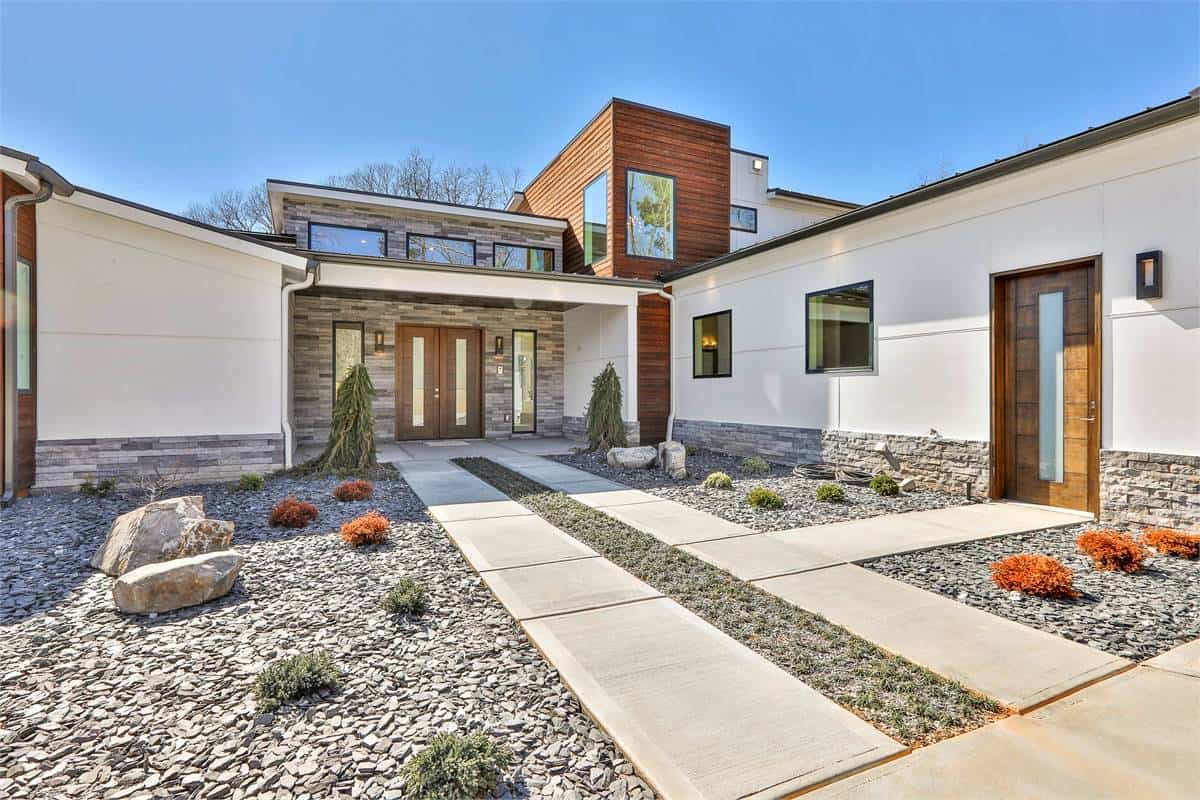 Front courtyard with a covered entry porch and a French front door.