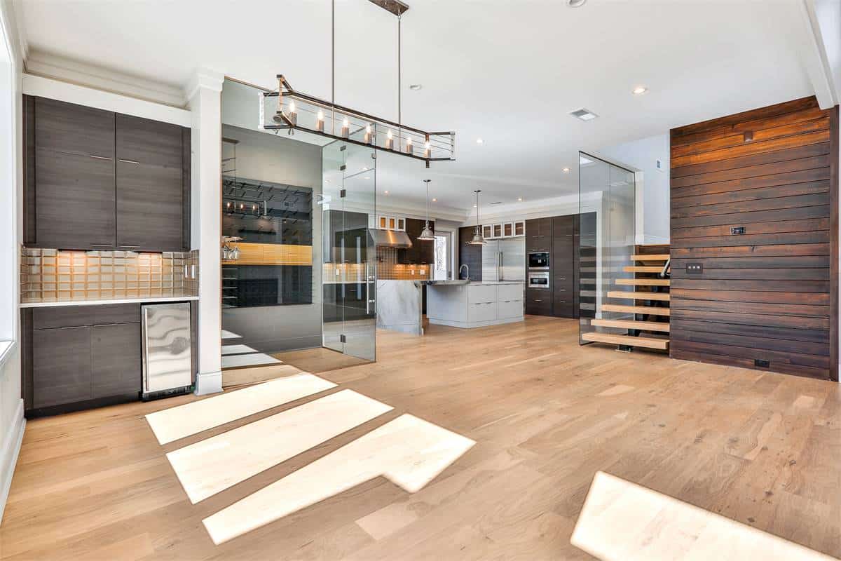 Dining area with a linear chandelier and a built-in bar.