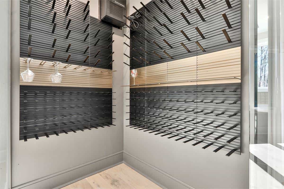 Wine room with built-in racks and glass enclosure.