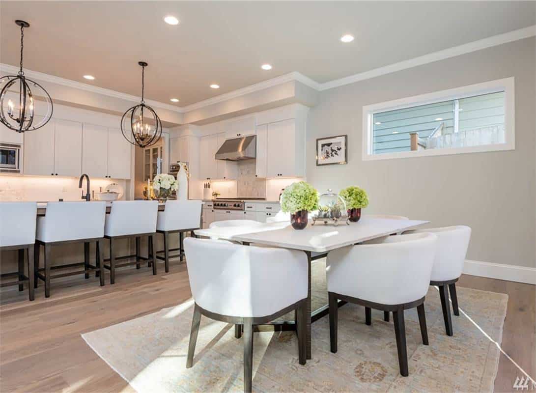 Breakfast nook with a 6-seater dining set over a floral area rug.