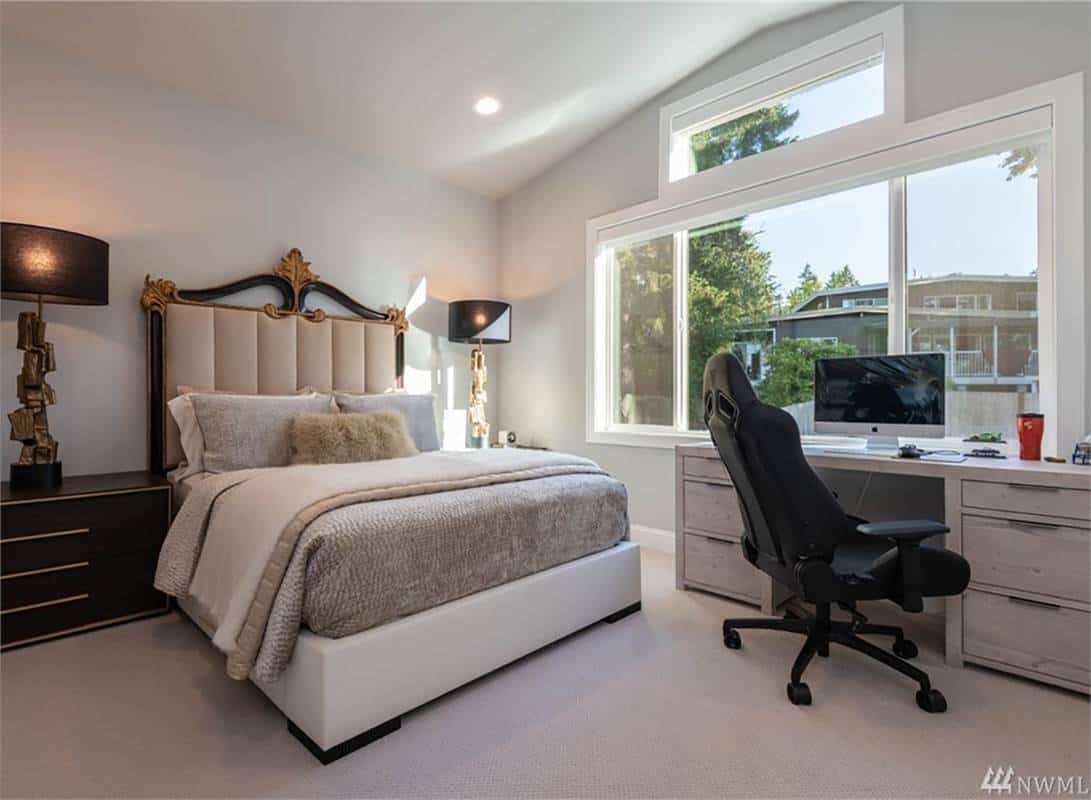 Secondary bedroom with platform bed, dark wood nightstands, and a white desk by the windows.