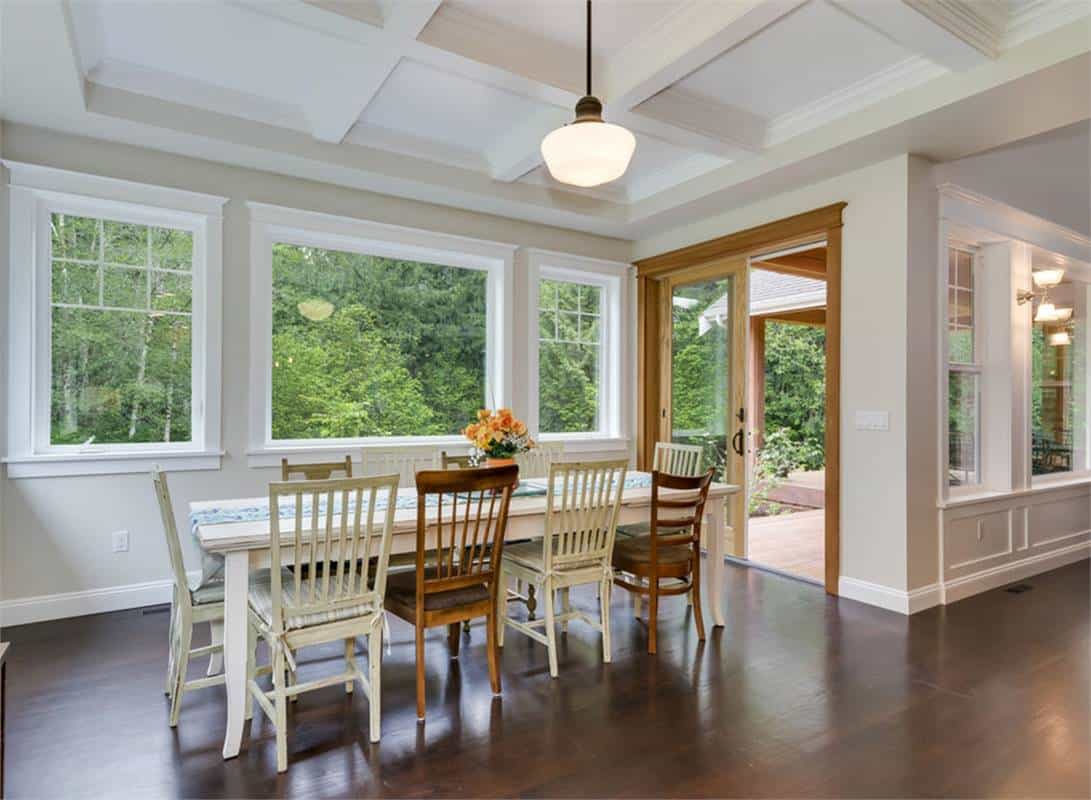Dining room with a coffered ceiling, a wooden dining set, and rear deck access via sliding glass doors.