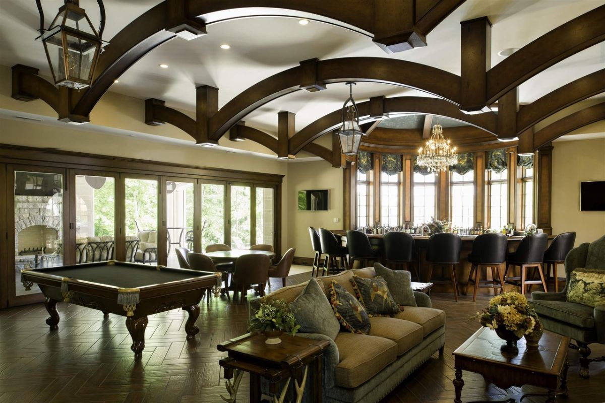 A billiard, chairs and a mini bar at the entertainment room.