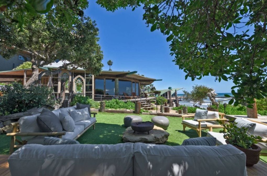 A Patio on top of a lush green field.