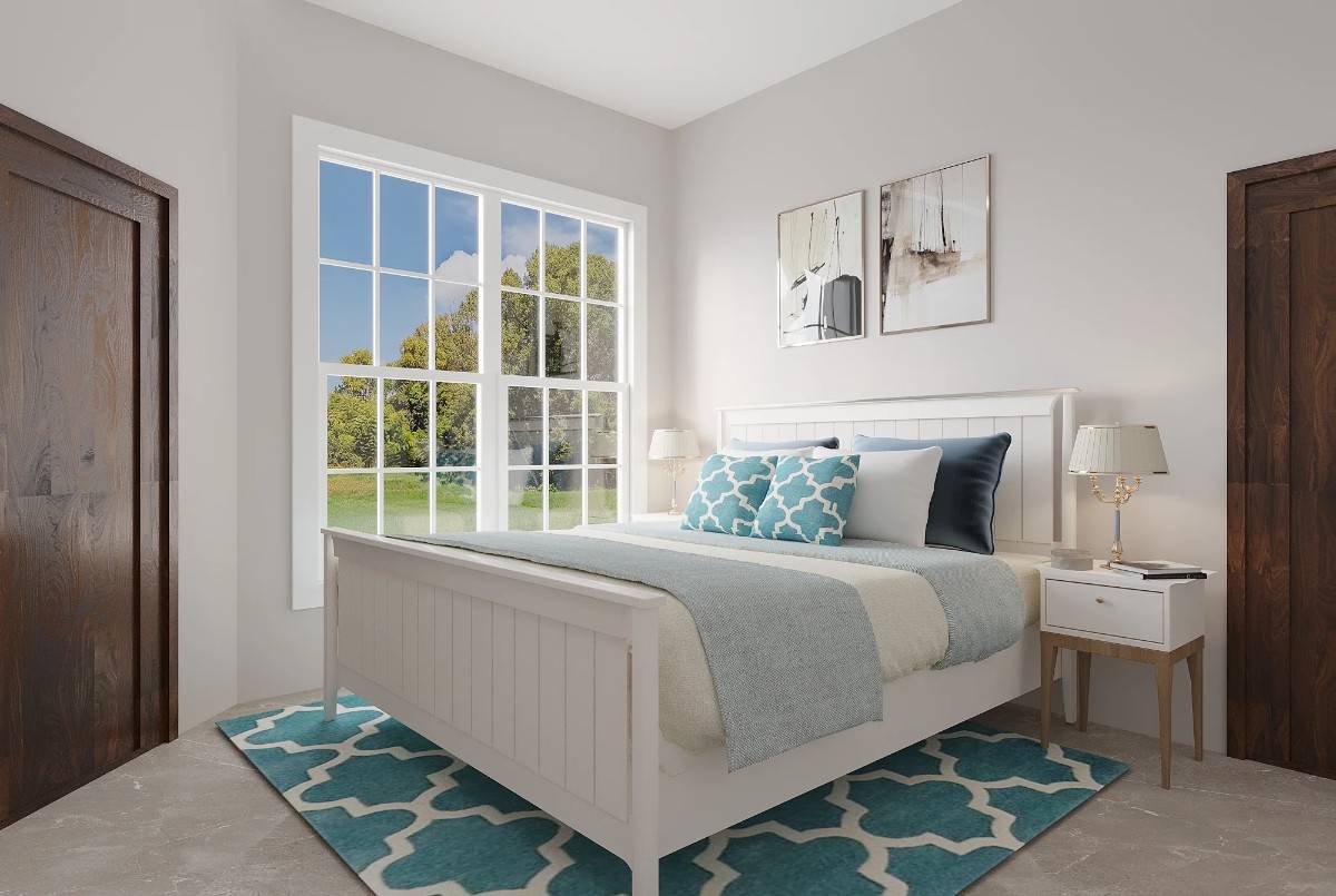Secondary bedroom with a white bed over the patterned area rug.