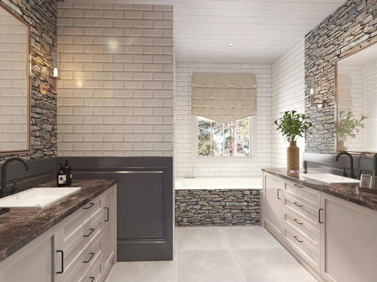Primary bathroom with his and her sink vanities and a drop-in bathtub clad in stackedstones.
