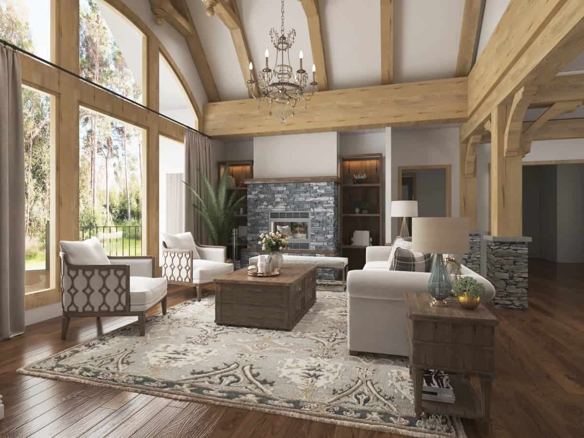 Lodge room with a stone fireplace, contemporary seats, a wall of windows, and a vaulted ceiling framed with exposed trusses.