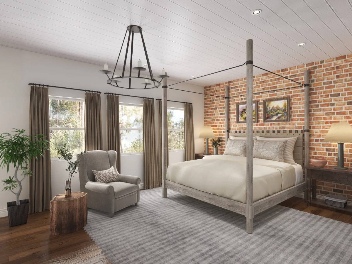 Primary bedroom with a brick accent wall and a canopy bed complemented with a wingback chair.