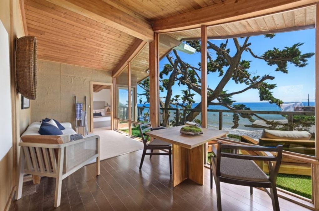 A separate tree house apartment with a kitchenette, living and dining room, bed and bath.