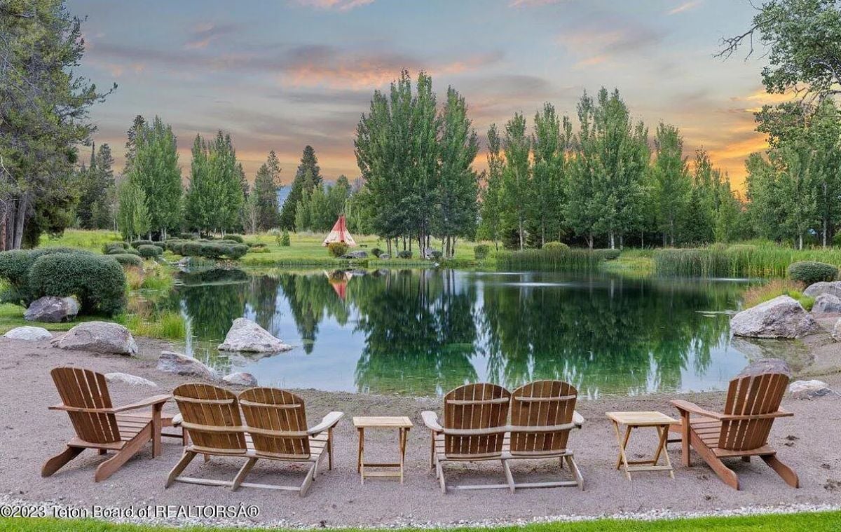 Pond with chairs in the backyard.