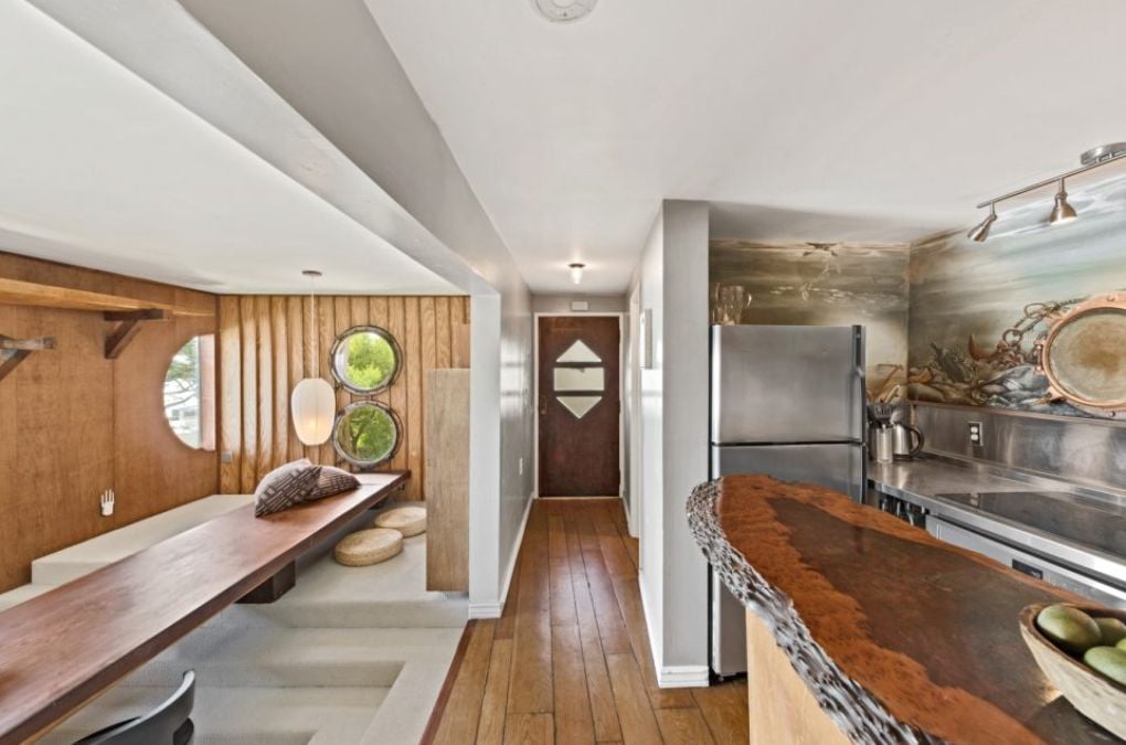 A separate boat house with a kitchen and bench seating.