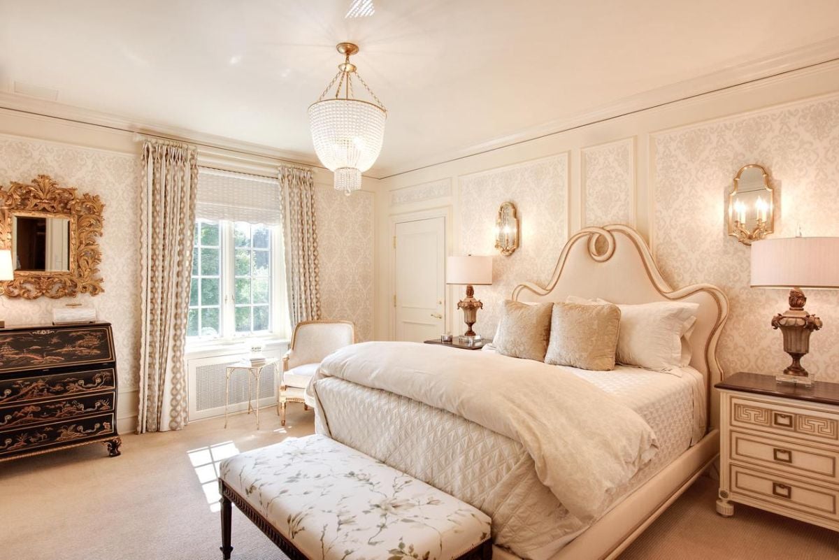 Bedroom with a chandelier, carpet flooring, and glass windows.