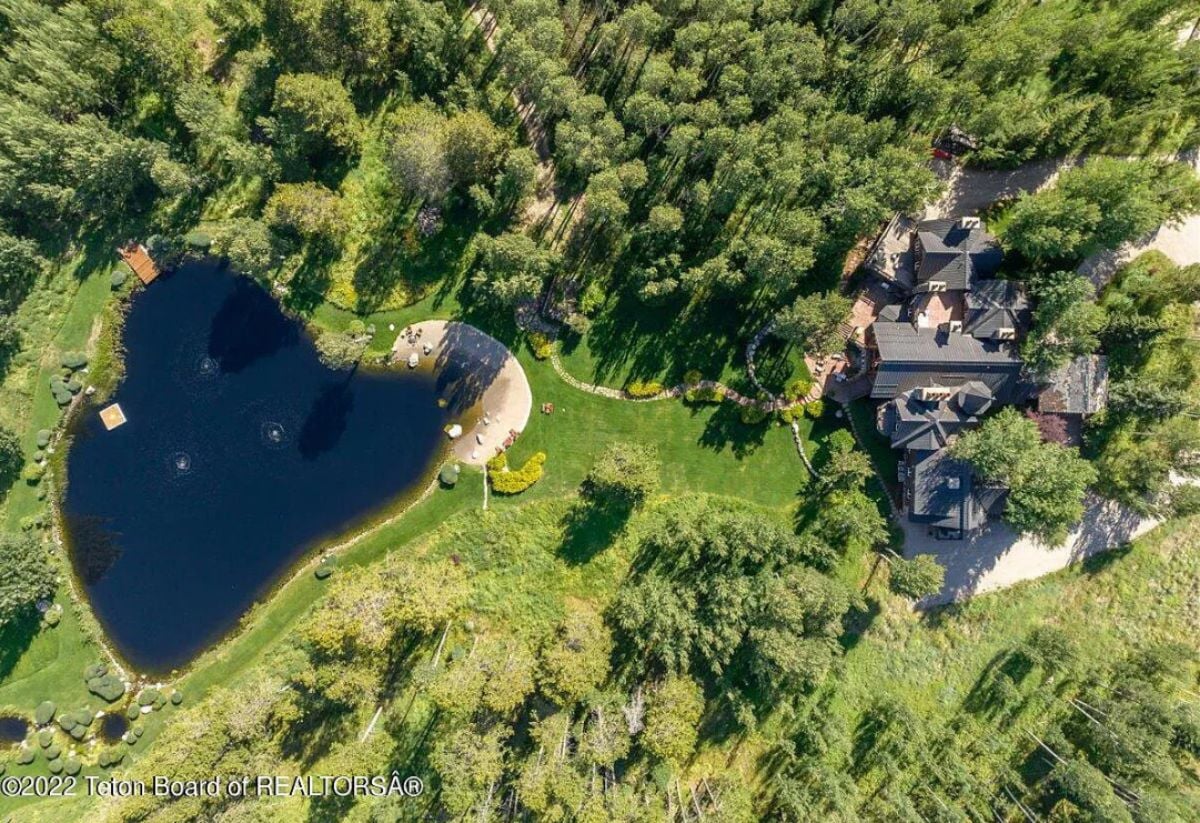 Aerial view of the property with a pond.