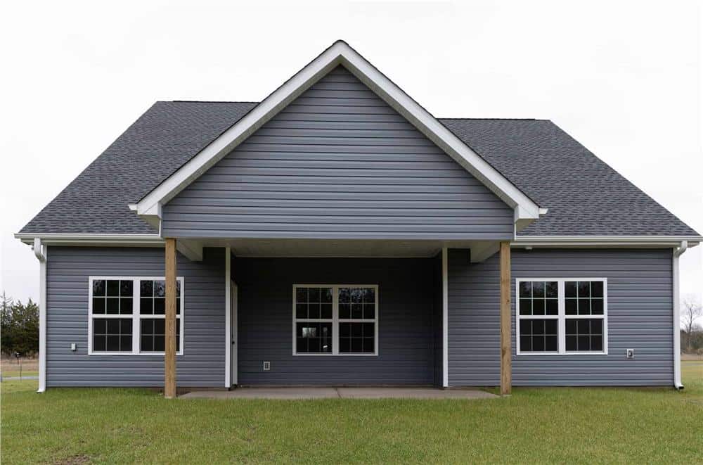 Rear view of the house showcasing the covered patio supported by wooden posts.