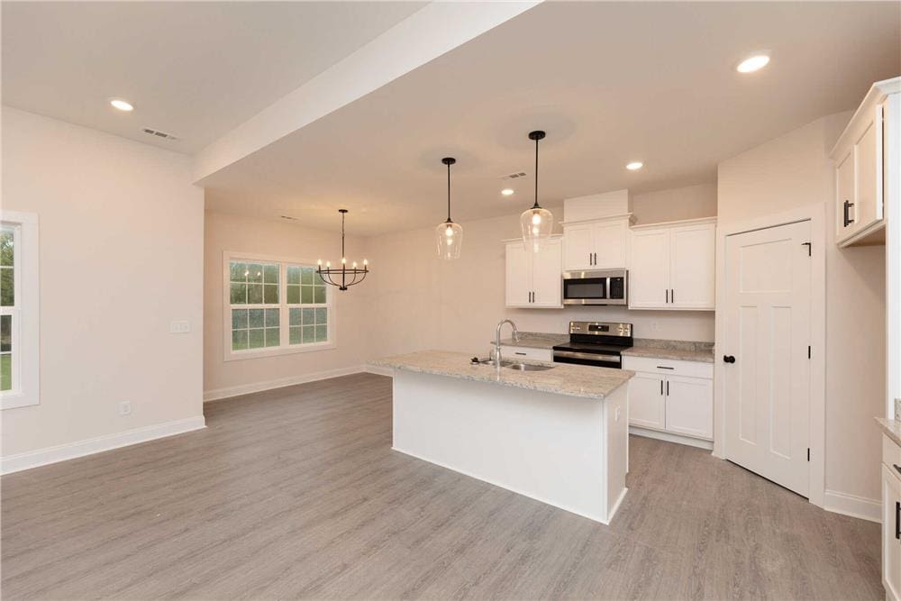 An oversized opening connects the family room and kitchen.