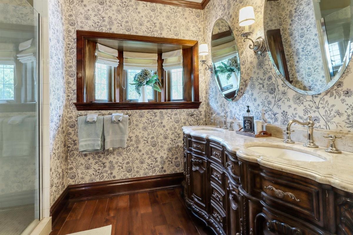 Bathroom with a sink, custom cabinetry, and a shower.