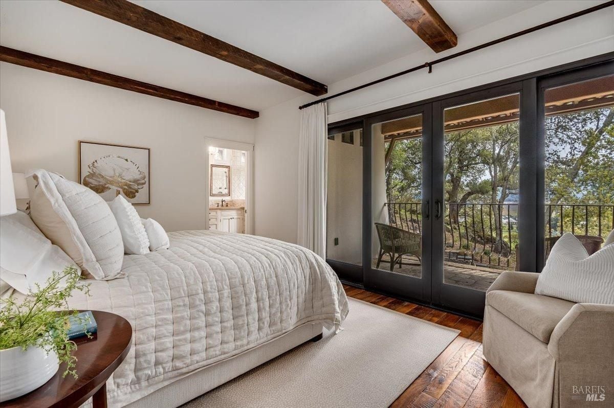 Bedroom with glass doors and a balcony.
